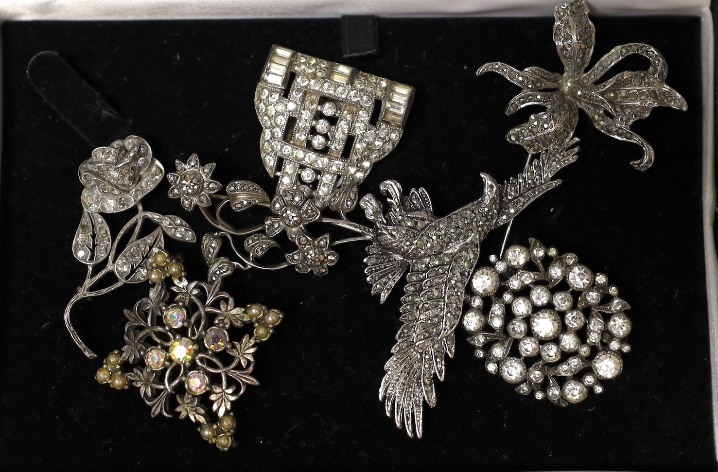 Seven assorted marcasite or paste brooches.